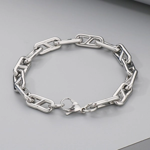 Macro detail of silver-tone stainless steel H-link bracelet with lobster clasp closure