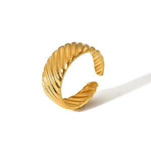 Macro detail of golden croissant ring with spiral rib texture and polished finish