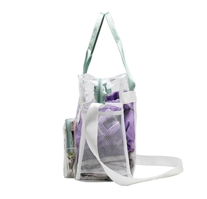Detail of transparent PVC beach bag featuring mint green straps and side mesh pocket
