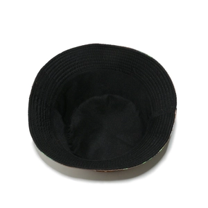 Detail view showing black inner lining and reinforced stitching of a patterned bucket hat
