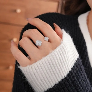 Macro shot of silver dual clover open ring with zircon inlay on model hand