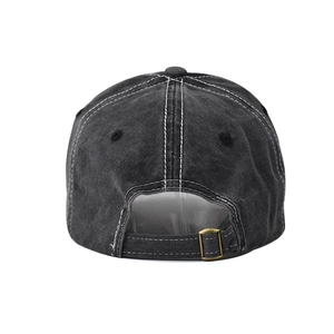Detail view of washed denim baseball cap back with adjustable brass metal buckle and stitching