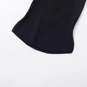 Close-up of black knit fabric backless top with adjustable metal ball strap detail
