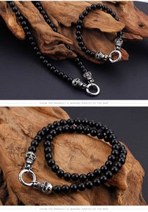 Detail of punk skull bracelet with black beads and vintage silver toggle clasp