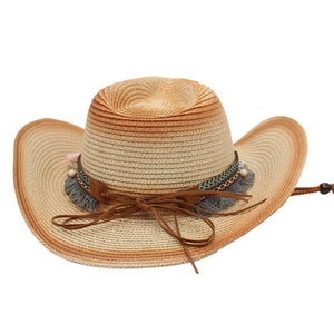 Detail of woven straw cowboy hat featuring decorative rope, beads, and fringe tassels