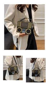 Detailed view of vintage radio shaped crossbody bag with golden dials and speaker design