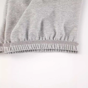 Close-up of grey newborn swaddle sleep sack showing premium cotton knit fabric and stitching