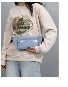 Close-up of light blue oxford fabric waist bag with colorful laser reflective patterns
