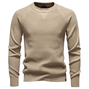 Detail of khaki waffle knit texture and round neck on a premium men's sweater