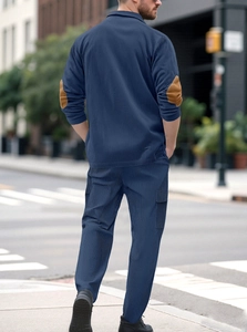 Detail of navy casual set showing ribbed texture and brown oval elbow patches on the back