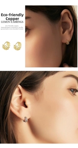 Close-up of eco-friendly copper leaf hoop earrings in gold and silver plating