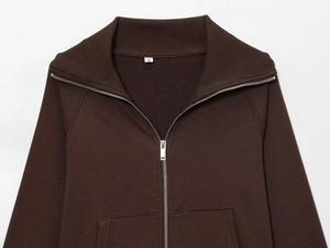 Detail of dark brown fleece sweatshirt showing zip collar and soft brushed texture