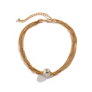 Detail of gold multi-strand chain necklace featuring a large grey pearl pendant