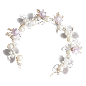 Detailed view of handmade bridal headband with gold leaves and pearl floral accents