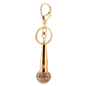 Golden microphone keychain with rhinestones shown on a clean white background