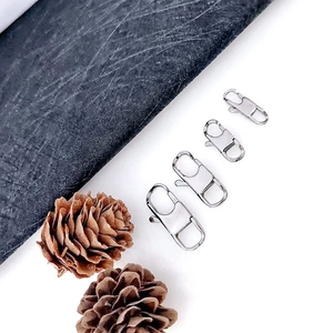 Detailed view of four silver stainless steel lobster clasps in various sizes for DIY jewelry