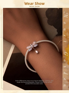 Detail of dragonfly charm bracelet with iridescent wings and mesh woven band