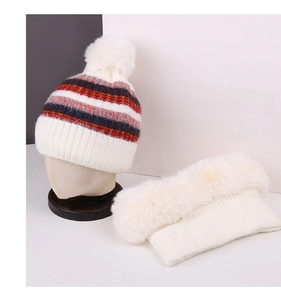Close-up of winter knit hat with colorful stripes and plush faux fur neck warmer set