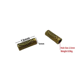 Macro view of 13mm bronze spacer beads with detailed fish pattern for jewelry making