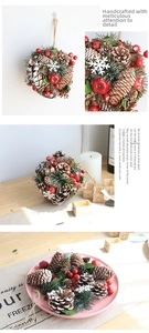 Detailed Christmas ornament featuring natural pine cones, red berries, and snow elements