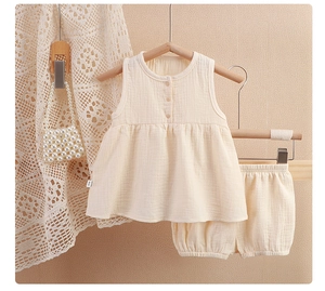 Detailed texture of baby double gauze cotton set featuring round neck and wooden buttons