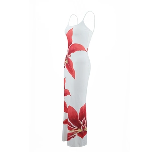 Detail view of the floral print on a slim fit white maxi dress with red flowers