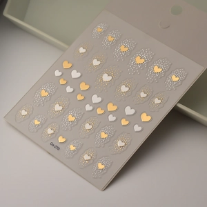 3D gold and white heart nail art stickers with embossed heart and dot patterns for manicure