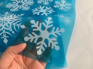 Detail of translucent blue Christmas snowflake window sticker showing transparency level