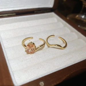 Detail of 18k gold plated butterfly stackable rings with champagne cubic zirconia stone