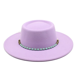 Detail of lavender felt flat top hat featuring ornate blue beaded chain trim