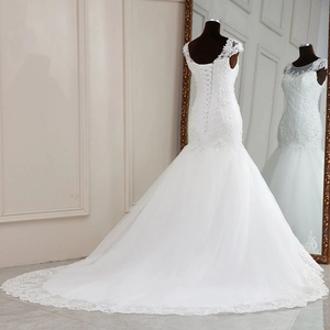 Detailed back view of a white lace mermaid wedding dress with open U-back and long train