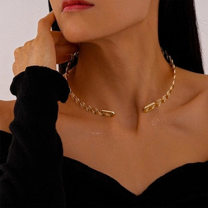 Detailed view of golden twisted rope metal choker necklace with smooth rectangle ends