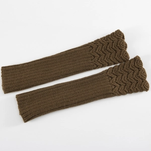 Detail of brown knitted arm warmers featuring a textured wave pattern and warm wool yarn