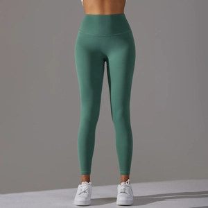 Detailed close-up of dark green high waisted yoga pants with a seamless peach lift design