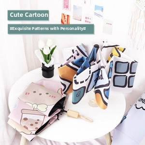 Detail of compact folding umbrella with cute cartoon prints and wooden handle
