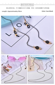 Detail of gunmetal eyeglass chain with gold accents and swirl lollipop charm