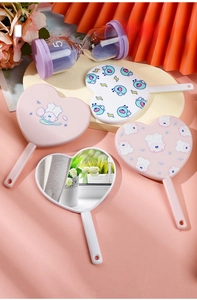 Group shot of heart-shaped portable makeup mirrors with handles in pink and white