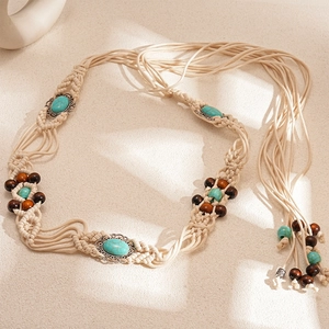 Detail of bohemian woven waist chain with turquoise stones and brown wooden beads