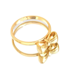 Elegant gold titanium steel ring featuring a pearl bow tie design on reflective surface