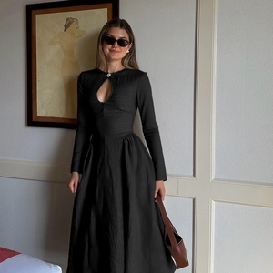Elegant black long sleeve dress with neckline cutout and pleated skirt for women