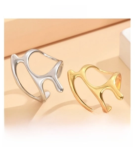 Close-up of liquid metal style irregular adjustable rings in gold and silver finish