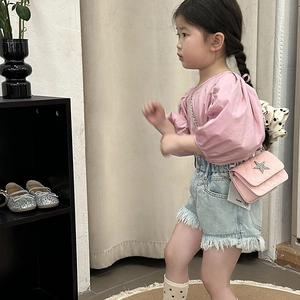 Pink quilted crossbody bag for kids with sparkling star detail and adjustable strap