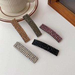 Set of five elegant rhinestone hair clips in champagne, green, purple, black, and silver