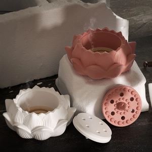 Detailed view of lotus incense burner set with petals and smoke on stone pedestal