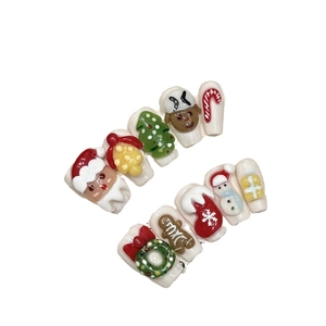 3D Christmas press-on nails with handmade Santa, gingerbread man, and festive tree designs
