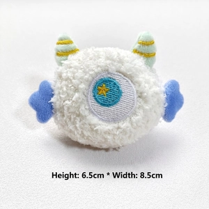 Detailed size view of plush monster charm with 6.5cm height and 8.5cm width dimensions