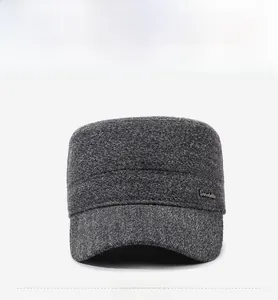 Front view of dark grey winter cadet cap showing thick textured wool fabric and metal logo