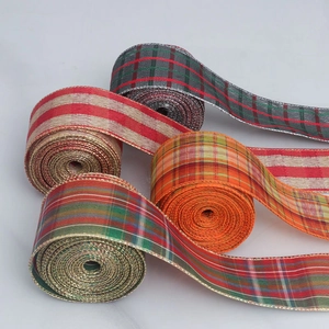 Close-up of Tartan plaid ribbons with golden wire edges in red, green and orange tones