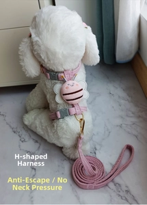 Detail of pink striped cat harness with cute bee decoration and adjustable golden D-ring