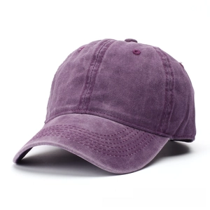 Detail of vintage purple washed cotton baseball cap with distressed finish and stitched brim
